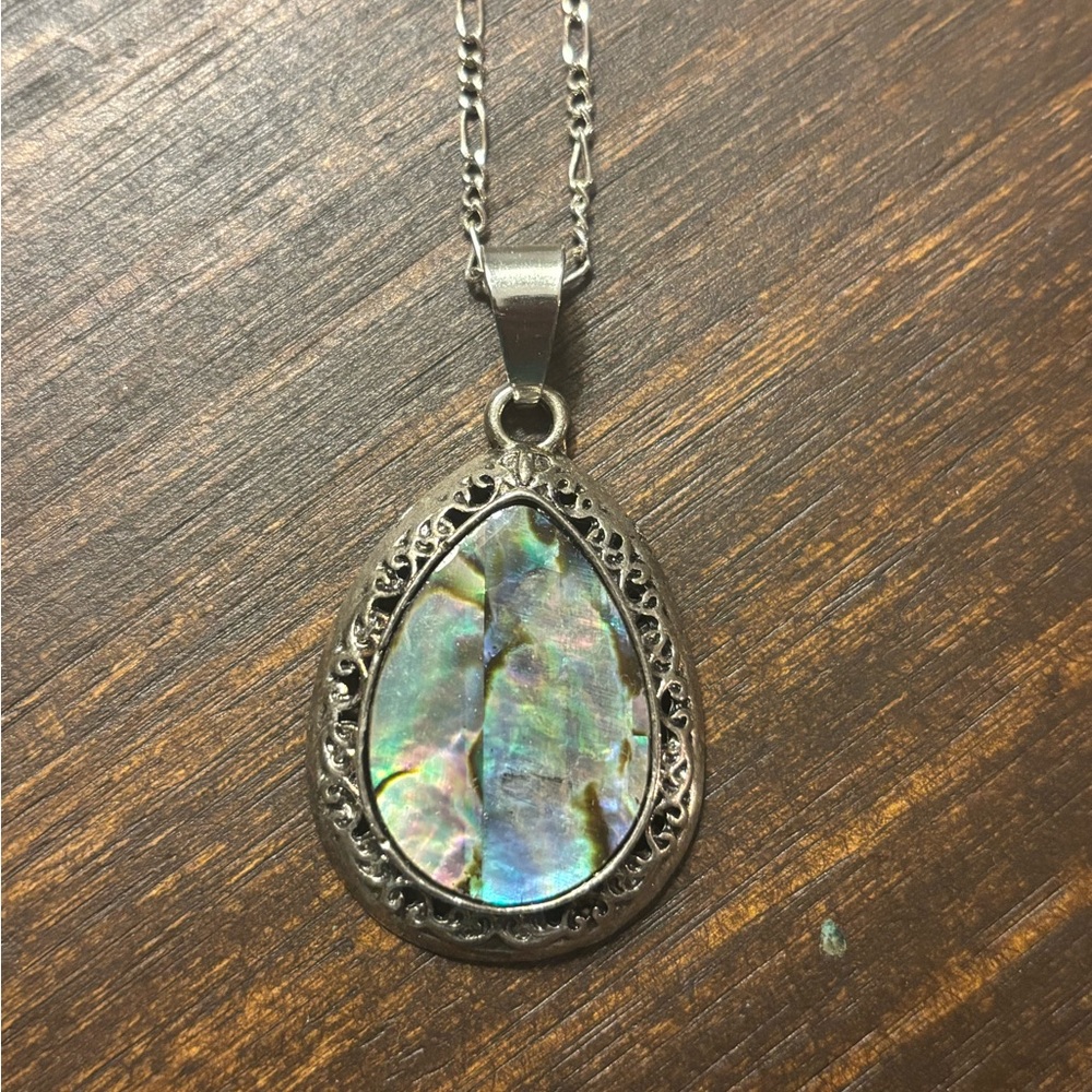 abalone pendant on a gold toned chain